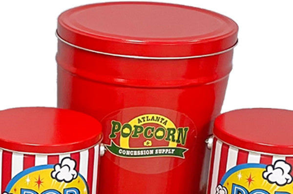 Three red metal popcorn-themed canisters with lids, including a tall central canister labeled 'Atlanta Popcorn & Concession Supply' and two shorter striped canisters at the sides, shown on a white background.